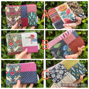 May include: A selection of six small, patchwork zipper pouches. Each pouch showcases a unique combination of patterned fabrics, including floral, polka dot, and animal prints. The pouches are in various colours, such as pink, green, and blue, and are held in hands against a green background.