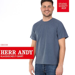 May include: A blue short-sleeved t-shirt with the text "HERR ANDY KLASSISCHES T-SHIRT" in a red rectangle. The image also includes the text "EBOOK" and "STUDIO SCHNITT REIF".