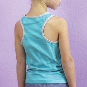 May include: A turquoise and blue striped tank top with gray trim. The tank top is a racerback style and is made of a soft, lightweight material. The tank top is shown on a person against a purple background.