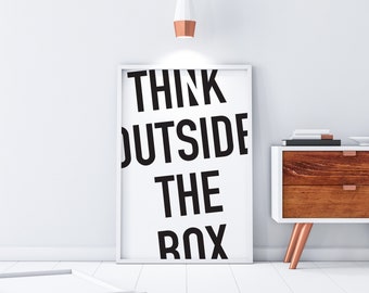 May include: A white framed poster with the text "Think Outside The Box" in black lettering.