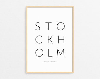 May include: A framed print with the word "STOCKHOLM" in black letters on a white background. The coordinates "59.3293°N, 18.0686°E" are printed below the word.