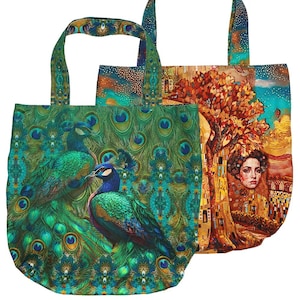 Könnte beinhalten: Zwei Tragetaschen mit Stoffgriffen. Die vordere Tasche zeigt ein lebhaftes Pfauenfeder-Muster in Grün und Blau mit zwei Pfauen. Die hintere Tasche zeigt einen farbenfrohen künstlerischen Druck eines Gesichts, umgeben von einem Baum und goldenen Mustern.