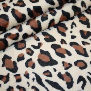 Sött rufsigt fleecetyg, brunt leopardmönster