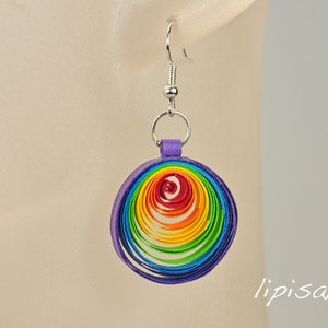 May include: Rainbow colored paper quilled earrings with a purple backing and silver hooks.