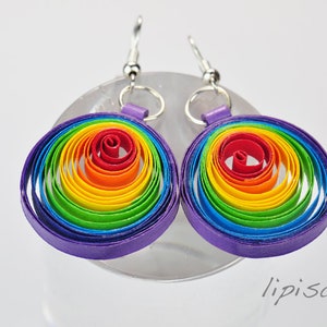 May include: Rainbow colored paper quilled earrings with a purple outer ring and silver hooks.