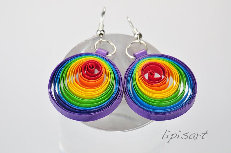 May include: Rainbow colored paper quilled earrings with a purple outer ring and silver hooks.