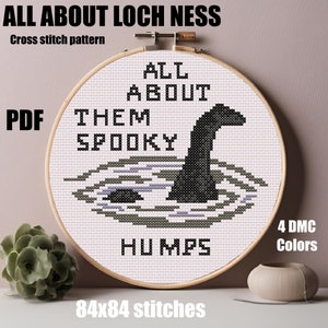 May include: A cross stitch pattern featuring a black and white illustration of the Loch Ness Monster with the text "All About Them Spooky Humps" and "84x84 stitches".