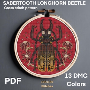 May include: A cross-stitch pattern of a Sabertooth Longhorn Beetle, displayed in a wooden embroidery hoop. The design features a detailed beetle in brown and yellow on a red background. Text includes "SABERTOOTH LONGHORN BEETLE", "Cross stitch pattern", "PDF", "100x100 Stitches", and "13 DMC Colors".
