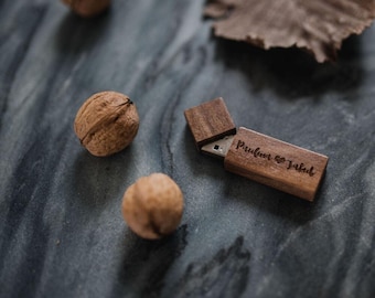 May include: A wooden USB flash drive with a sliding cover. The drive is engraved with the text "Paulina & Jakob" and a heart symbol.