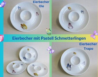 Flat porcelain egg cups: Various butterflies in blue, green, pink, orange, purple. Egg cups are a souvenir for many occasions