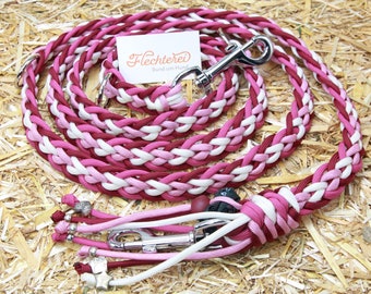 Handmade flat dog leash made of a paracord mix of pink, fuchsia, burgundy and white in a heart pattern with a practical dog bag dispenser