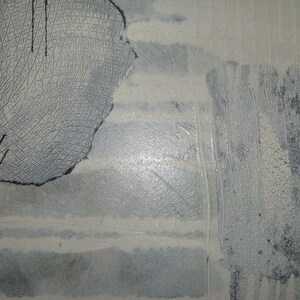 May include: Abstract painting with a textured, gray and white background. A large, circular, black and white design is in the upper left corner.