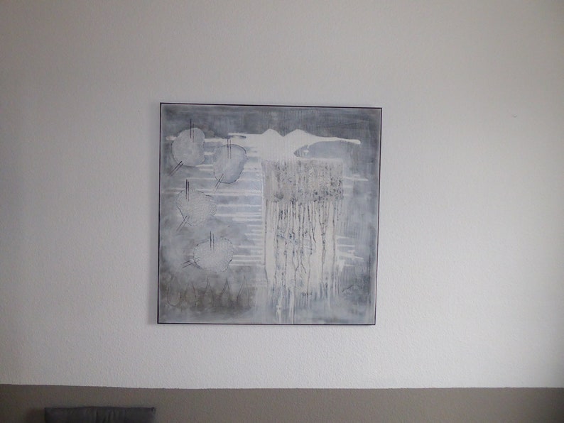 May include: Abstract painting with a white, gray, and black color scheme. The painting features a white shape that resembles a bird or a cloud, with a series of vertical lines in the background.
