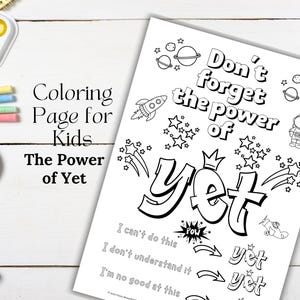 May include: A black and white coloring page for kids with the text "Don't forget the power of Yet". The page includes illustrations of stars, planets, a rocket, and an astronaut. Other art supplies are visible.