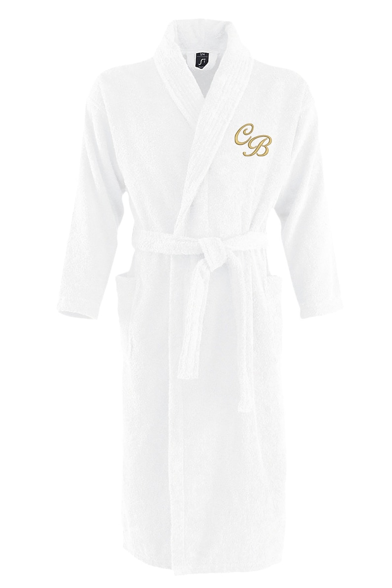 May include: White bathrobe with a long sleeve and a belt. The robe has a gold embroidered monogram "CB" on the left chest.