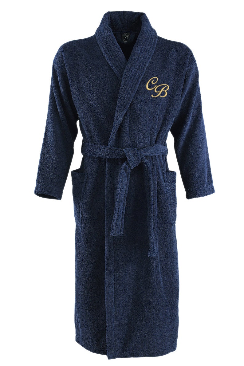 May include: A navy blue bathrobe with a white collar and a gold embroidered monogram "CB".