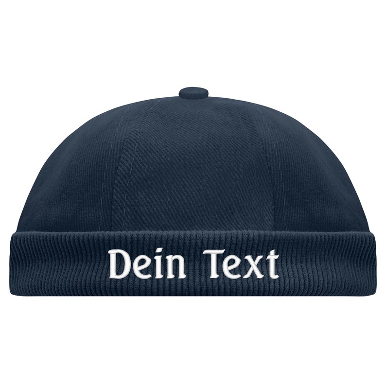 May include: A navy blue corduroy beanie with a white embroidered text that says "Dein Text".