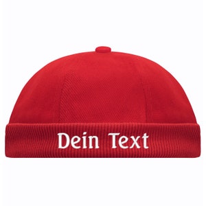 May include: Red corduroy beanie with a white embroidered text that says "Dein Text".