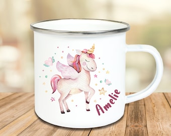 May include: White enamel mug with a silver rim and handle, decorated with a watercolour unicorn illustration. The unicorn has a pink mane, wings, and a golden horn. The name "Amelie" is written in pink script on the mug.