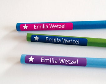May include: Three blue, green, and purple pencils with white star stickers and the name "Emilia Wetzel" printed on each.