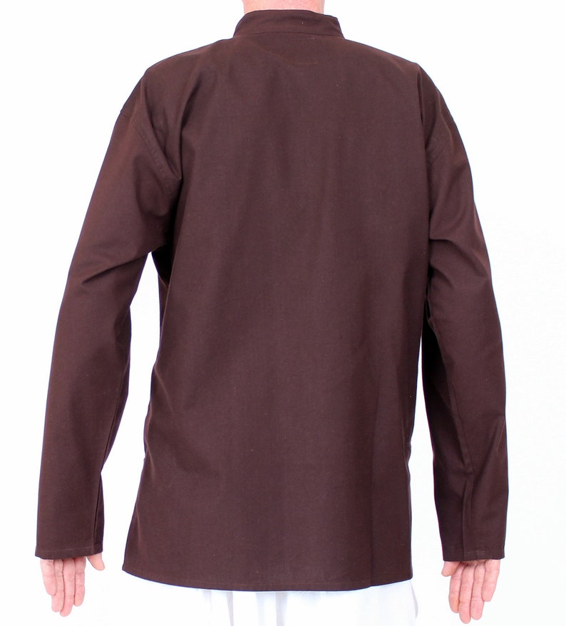 May include: A brown long-sleeved shirt with a mandarin collar. The shirt is made of a solid, dark brown fabric. The sleeves have buttoned cuffs. The shirt is shown from the back.