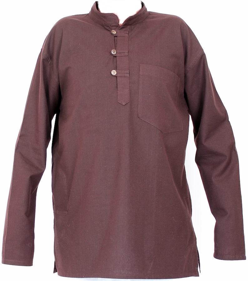 May include: A long-sleeved, brown tunic shirt with a mandarin collar and a single chest pocket. The shirt features three wooden buttons down the placket and a relaxed fit. The fabric appears to be a lightweight cotton or linen blend.