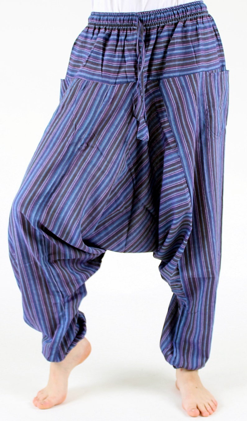 May include: Harem pants with a striped pattern in shades of blue, purple, and black. The pants have a drawstring waist and pockets. The loose fit and gathered ankles create a relaxed silhouette. The pants are made of a lightweight fabric.