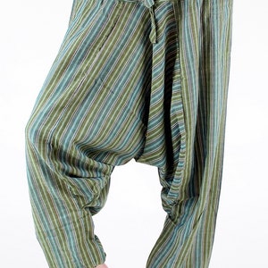 May include: Green and blue striped harem pants with a drawstring waist and pockets. The loose-fitting pants have a relaxed, comfortable style. The vertical stripes alternate between shades of green, blue, and white.