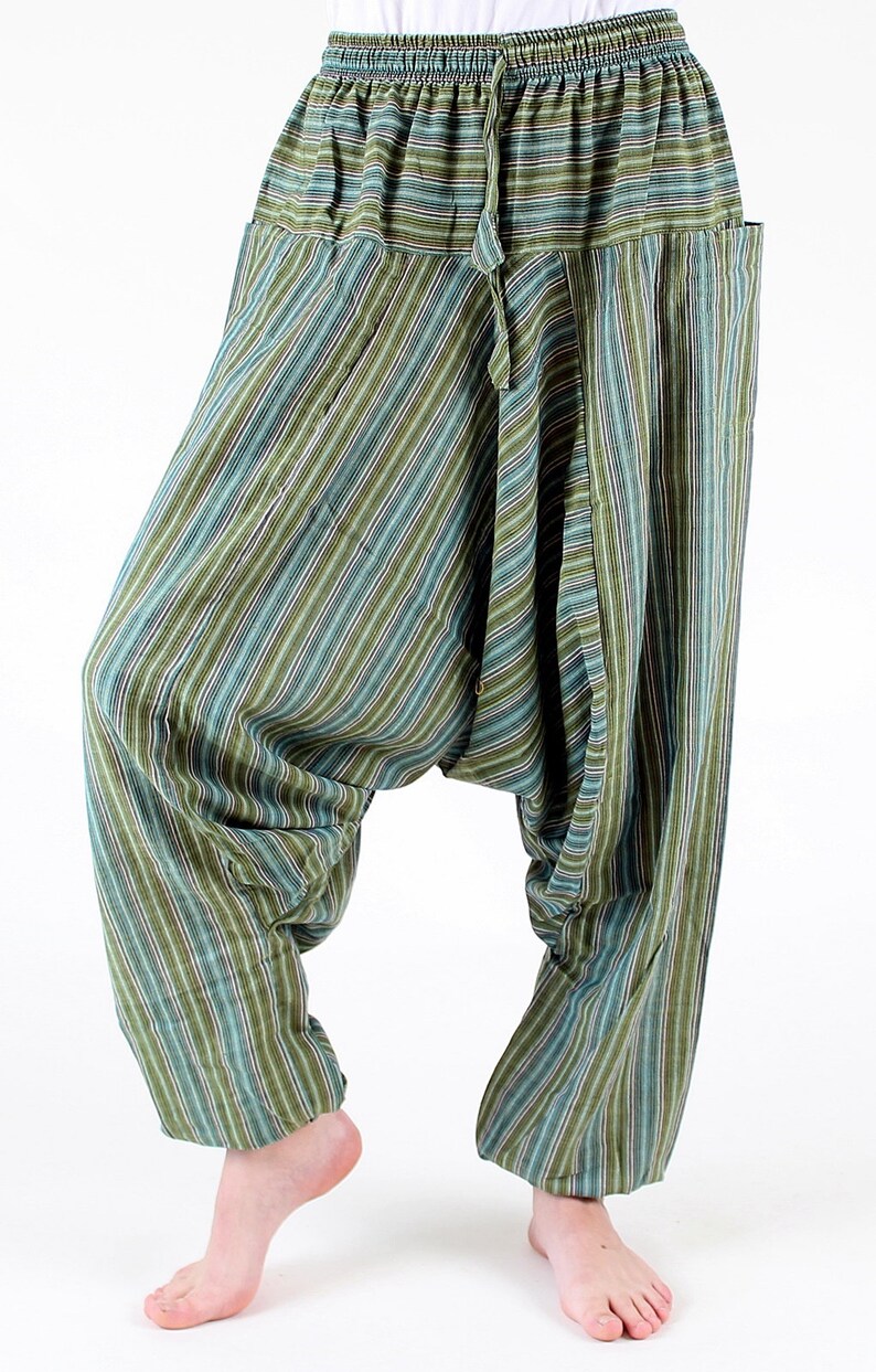 May include: Green and blue striped harem pants with a drawstring waist and pockets. The loose-fitting pants have a relaxed, comfortable style. The vertical stripes alternate between shades of green, blue, and white.