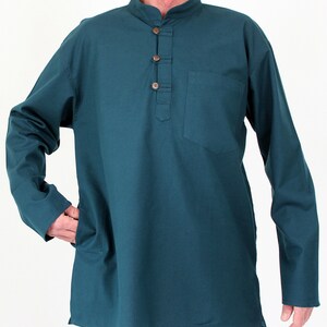 May include: Teal long-sleeve shirt with a mandarin collar and a button-down placket. The shirt features a single chest pocket and two side pockets. The buttons are a light brown color. The shirt is made of a soft, comfortable material.