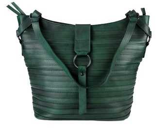 May include: A dark green leather handbag with a single strap and a metal ring detail. The bag has a textured, horizontal striped design.