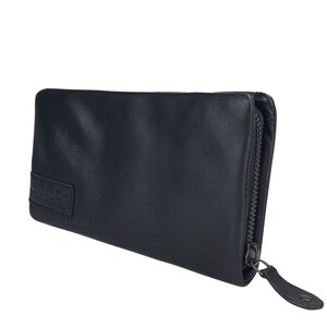 May include: A black leather zippered wallet with the word "hamburgefrit" embossed on the front.