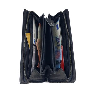 May include: A black leather zippered wallet with multiple compartments, open to reveal cash and credit cards.