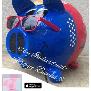May include: A blue and red piggy bank with a straw hat and sunglasses. The piggy bank has the text "by Individual- Piggy Banks®" written on it.