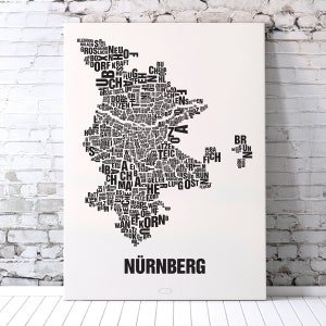 May include: A black and white word cloud art print of the city of Nuremberg, Germany. The word cloud is shaped like the city's outline and includes many of the city's neighborhoods and landmarks. The print is titled "N&uuml;rnberg" at the bottom.