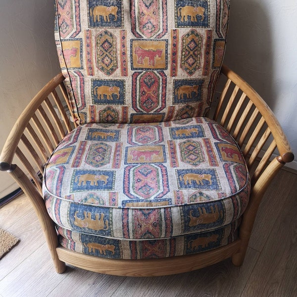 Ercol renaissance armchair in blonde. Original seat pads and covers.