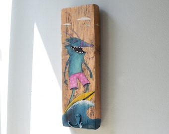 Hand-painted driftwood board as wall hook with a monster as surfer - sea
