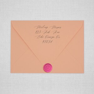 May include: A peach-colored envelope with a pink wax seal. The address is handwritten in black ink: Sterling Striper, 123 Ash Ave, Lake Oswego, OR 97034.