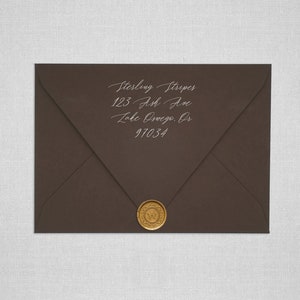 May include: A brown envelope with a gold wax seal. The address is written in white ink: Sterling Stripes, 123 Ash Ave, Lake Oswego, OR 97034.