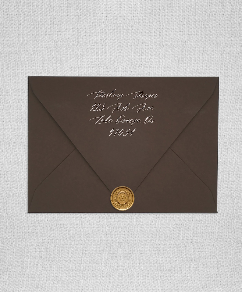 May include: A brown envelope with a gold wax seal. The address is written in white ink: Sterling Stripes, 123 Ash Ave, Lake Oswego, OR 97034.