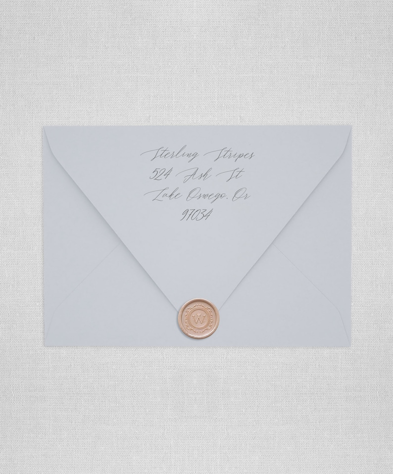 May include: A light blue envelope with a wax seal. The envelope has an address written on it: Sterling Stripes, 524 Ash St, Lake Oswego, OR 97034.