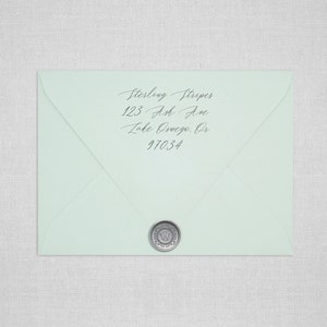 May include: A light blue envelope with a silver wax seal. The address is written in cursive: Sterling Stripes, 123 Ash Ave, Lake Oswego, OR 97034.