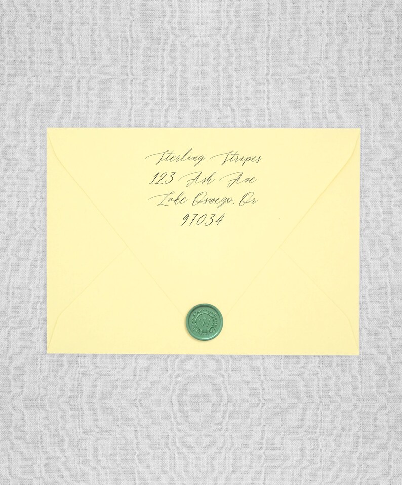 May include: A yellow envelope with a green wax seal. The address is written in cursive: Sterling Stripes, 123 Ash Ave, Lake Oswego, OR 97034.