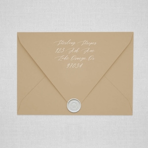 May include: A brown envelope with a white wax seal. The address is written in white cursive: Sterling Stripes, 123 Ash Ave, Lake Oswego, OR 97034.