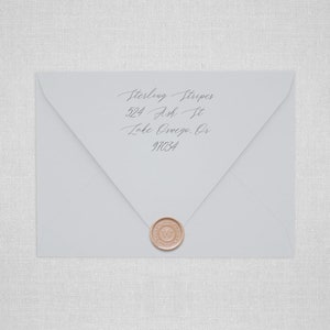 May include: A white envelope with a wax seal. The envelope has an address written on it: Sterling Stripes, 524 Ash St, Lake Oswego, OR 97034.