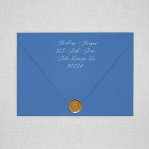 May include: A blue envelope with a gold wax seal. The address is written in white ink: Sterling Stripes, 123 Ash Ave, Lake Oswego, OR 97034.