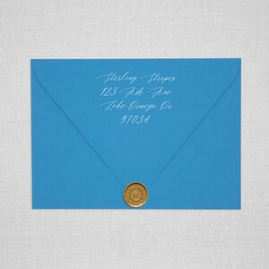 May include: A blue envelope with a gold wax seal. The address is written in white ink: Sterling Stripes, 123 Ash Ave, Lake Oswego, OR 97034.