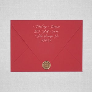May include: A red envelope with a wax seal. The address is written in white ink: Sterling Stripes, 123 Ash Ave, Lake Oswego, OR 97034.
