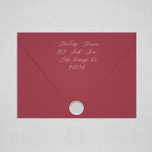 May include: A red envelope with a white wax seal. The address is written in white ink: Sterling Stripes, 123 Ash Ave, Lake Oswego, OR 97034.