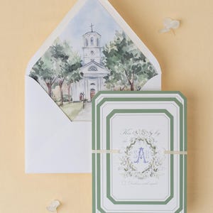 May include: Wedding invitation set with a watercolour church illustration inside the envelope. The invitation card has a white background, green border, floral design, and the initials "SA". A cream ribbon secures the invitation.